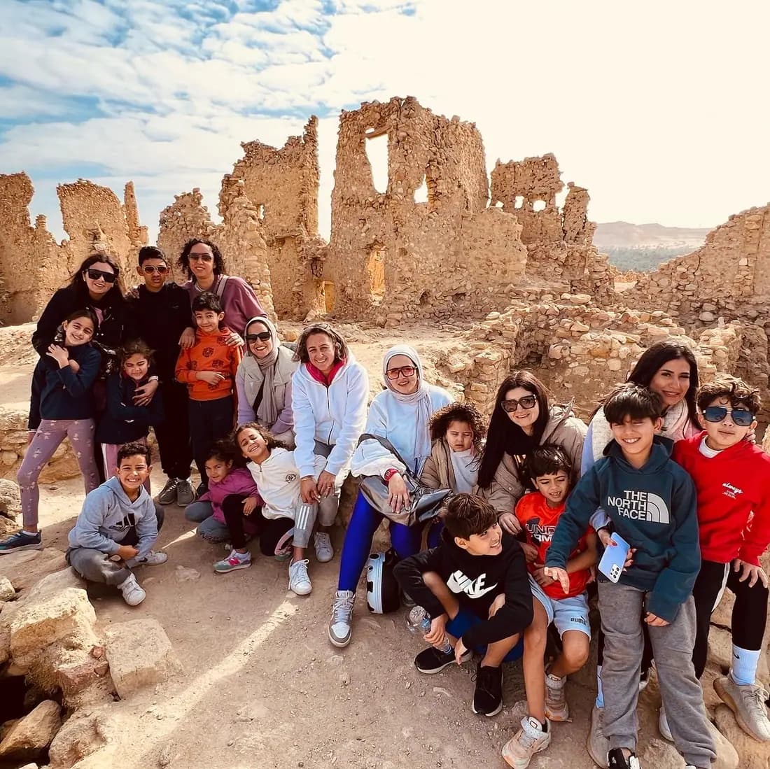 Families and children exploring ancient ruins in Siwa