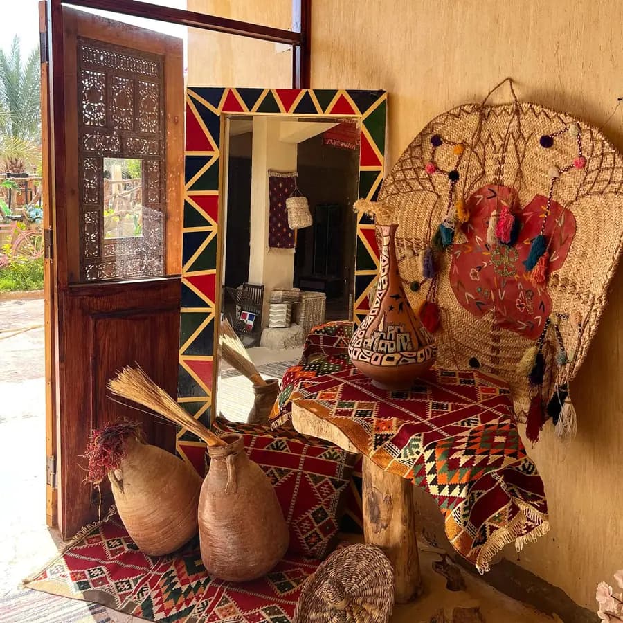 A corner of Siwan crafts: painted door, mirror and woven baskets