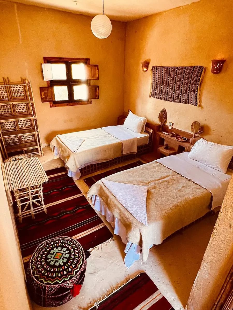 A Siwan guest room with woven textiles and warm lighting